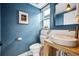 Charming bathroom with blue walls, a unique sink, and stylish fixtures at 3615 Lipan St, Denver, CO 80211