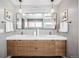 Modern bathroom boasts double sink vanity with wood cabinets and a large mirror at 3615 Lipan St, Denver, CO 80211