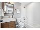 This bathroom includes a modern sink, toilet, tub and shower at 3615 Lipan St, Denver, CO 80211