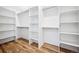 Large walk-in closet with built-in shelving and hardwood floors at 3615 Lipan St, Denver, CO 80211