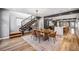 Open concept dining area with modern staircase, hardwood floors, stylish furniture, and plenty of natural light at 3615 Lipan St, Denver, CO 80211