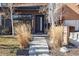 Inviting front entrance with modern design, xeriscape landscaping, and concrete walkway leading to the front door at 3615 Lipan St, Denver, CO 80211