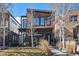 Contemporary two-story home with a modern design, contrasting wood and brick, and professional landscaping at 3615 Lipan St, Denver, CO 80211