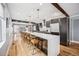 Modern kitchen with oversized island, stainless steel appliances, and open layout to the living area at 3615 Lipan St, Denver, CO 80211