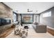 Cozy living room with modern furniture, a fireplace, and a unique garage-style door to the backyard at 3615 Lipan St, Denver, CO 80211