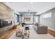 Comfortable living room with a fireplace, modern seating, and a glass garage door that opens to the backyard at 3615 Lipan St, Denver, CO 80211