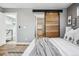 Bedroom featuring a large, sliding barn door leading to closet, and ensuite bathroom at 3615 Lipan St, Denver, CO 80211