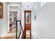 Staircase with black railings, a light fixture, and a window with tree views and a peak at the living room at 3615 Lipan St, Denver, CO 80211