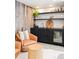 Stylish bar area features custom cabinets, open shelving, wine fridge, and rustic wood accent wall at 18910 Augusta Dr, Monument, CO 80132