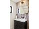 Stylish bathroom featuring a modern vanity, sleek mirror, and a beautifully accented wood wall at 18910 Augusta Dr, Monument, CO 80132