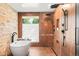 Bathroom showcasing a freestanding tub, stone accent wall, and a glass enclosed shower with dual shower heads at 18910 Augusta Dr, Monument, CO 80132