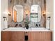 Bathroom featuring a dual sink vanity with wood accents, modern fixtures, and decorative lighting at 18910 Augusta Dr, Monument, CO 80132