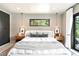 Bedroom featuring pendant lights, a neutral color scheme, and a window overlooking trees at 18910 Augusta Dr, Monument, CO 80132