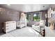 Charming Bedroom with soft lighting, comfortable seating, and a tranquil atmosphere, perfect for a new baby at 18910 Augusta Dr, Monument, CO 80132