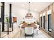 Bright dining room with modern light fixture, wood accent wall, and stylish decor at 18910 Augusta Dr, Monument, CO 80132