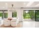 Bright and airy dining space featuring golf course views and modern lighting at 18910 Augusta Dr, Monument, CO 80132