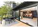 Exterior view from deck into a modern kitchen with barstool seating and sliding glass door at 18910 Augusta Dr, Monument, CO 80132