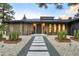 Modern home with rustic wood siding and a stone walkway leading to the front door at 18910 Augusta Dr, Monument, CO 80132