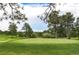 Well-manicured golf course green surrounded by mature trees and scenic views at 18910 Augusta Dr, Monument, CO 80132