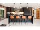 Modern kitchen with an island with bar seating, stainless steel appliances, and dark cabinetry at 18910 Augusta Dr, Monument, CO 80132