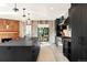 Modern kitchen featuring an island with pendant lights, wood accents, and stainless steel appliances at 18910 Augusta Dr, Monument, CO 80132