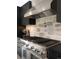 Close-up of stainless steel range with stone backsplash and pot filler faucet in modern kitchen at 18910 Augusta Dr, Monument, CO 80132