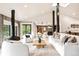 Bright and open living room with vaulted ceilings, modern fireplace, and comfortable seating at 18910 Augusta Dr, Monument, CO 80132