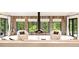 Cozy living room with a modern fireplace, large windows, and serene backyard views at 18910 Augusta Dr, Monument, CO 80132
