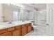 Bathroom featuring double sinks, and a tiled walk-in shower at 9471 Crossland Way, Highlands Ranch, CO 80130