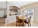 Dining area with hardwood floors and backyard views provides a cozy setting at 9471 Crossland Way, Highlands Ranch, CO 80130