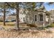 Side view of home features a landscaped yard with mature trees and ample parking at 9471 Crossland Way, Highlands Ranch, CO 80130