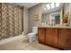 Well-lit bathroom features a shower-tub combination, a toilet and a vanity with sink at 85 Rampart Way # 206, Denver, CO 80230