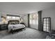 Spacious primary bedroom featuring neutral colors, a bench, carpet floors, and natural light at 85 Rampart Way # 206, Denver, CO 80230