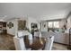 Open-concept layout featuring a dining area with wood floors and adjacent living room at 85 Rampart Way # 206, Denver, CO 80230