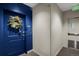 Condo entrance featuring a blue door adorned with a decorative wreath at 85 Rampart Way # 206, Denver, CO 80230