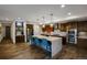 Modern kitchen featuring a large island with bar stools, stainless steel appliances, and designer finishes at 85 Rampart Way # 206, Denver, CO 80230