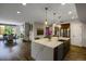 Open floor plan featuring a kitchen island with a sink, chairs, and view to the dining and living area at 85 Rampart Way # 206, Denver, CO 80230