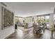 Open-concept living and dining area featuring hardwood floors and large windows with views at 85 Rampart Way # 206, Denver, CO 80230