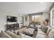 Open-plan living room with access to a balcony and stylish decor at 85 Rampart Way # 206, Denver, CO 80230