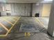 Designated parking spot in underground garage with handicapped parking symbol and exit door nearby at 85 Rampart Way # 206, Denver, CO 80230