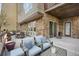 Inviting patio is perfect for outdoor dining and entertaining with comfortable chairs at 85 Rampart Way # 206, Denver, CO 80230