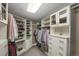 Organized walk-in closet featuring custom built-in shelving, hanging racks, and a neutral color palette at 85 Rampart Way # 206, Denver, CO 80230