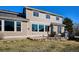 The backyard has a patio with stone decor, chairs, a table, and a grill at 2460 Switch Grass Way, Castle Rock, CO 80109