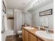 Bright bathroom featuring a shower over tub and double sink vanity at 2460 Switch Grass Way, Castle Rock, CO 80109