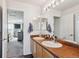 Bathroom with double sink vanity, modern fixtures, and neutral decor at 2460 Switch Grass Way, Castle Rock, CO 80109
