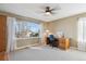 Bright bedroom features a large window, ceiling fan, and a built-in desk area at 2460 Switch Grass Way, Castle Rock, CO 80109