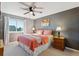 Bedroom with a dark gray accent wall, pink comforter and ceiling fan at 2460 Switch Grass Way, Castle Rock, CO 80109
