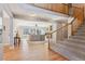 Bright entryway featuring wood floors, staircase, and an open view to the living room at 2460 Switch Grass Way, Castle Rock, CO 80109