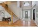 Inviting foyer with hardwood floors, staircase, and a view of the front door at 2460 Switch Grass Way, Castle Rock, CO 80109