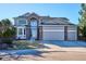 Charming two-story home with a three-car garage and well-manicured front yard at 2460 Switch Grass Way, Castle Rock, CO 80109
